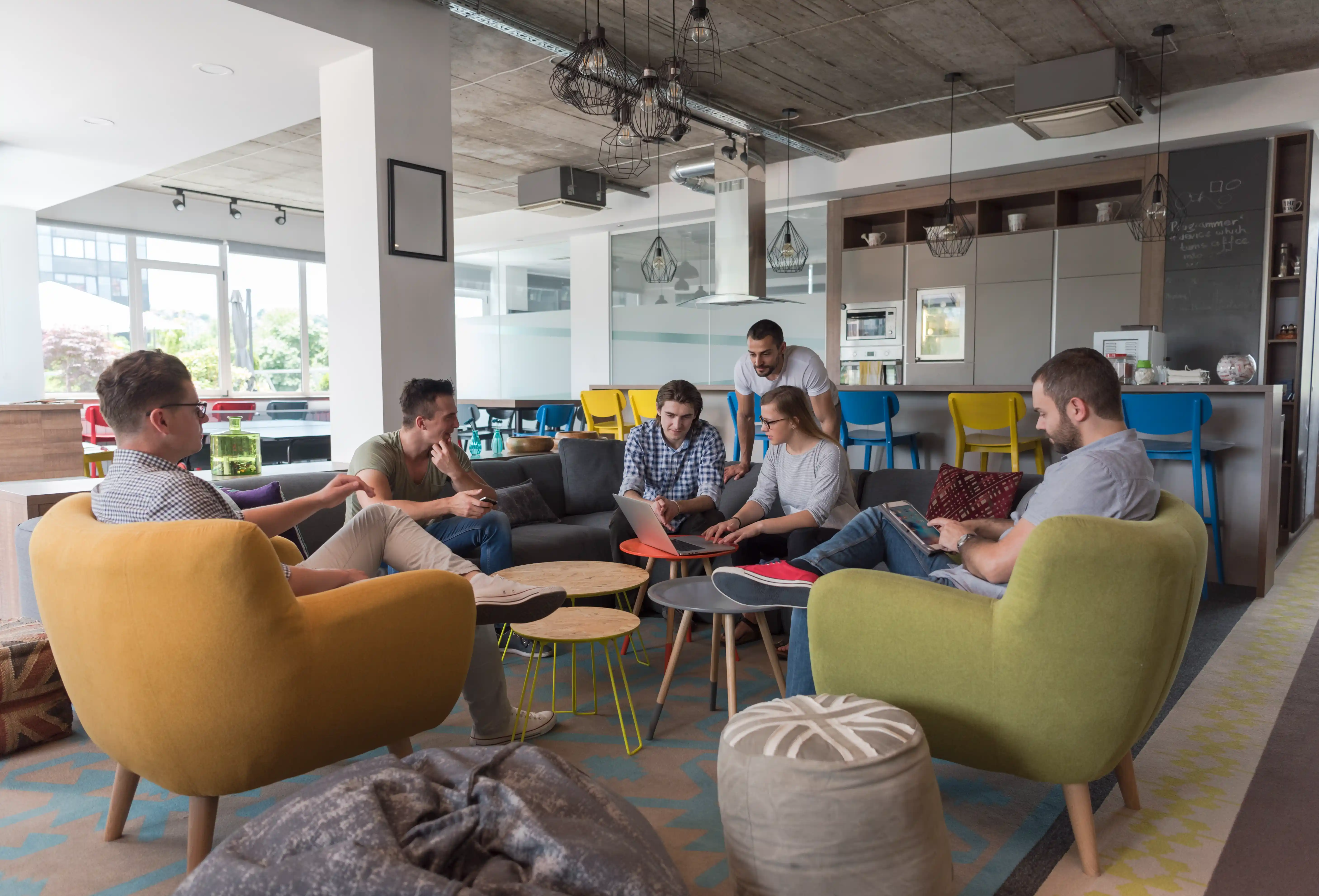 Team brainstorming around a laptop in a modern office